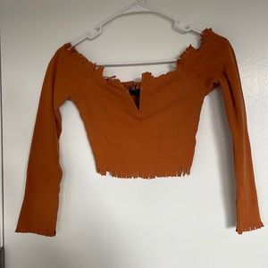 Kittenish off shoulder cropped fringe shirt